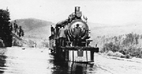 A CPR locomotive negotiating a flooded track