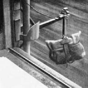 SUSPENDED ON A STEEL ARM the mail-bag is swept through the air